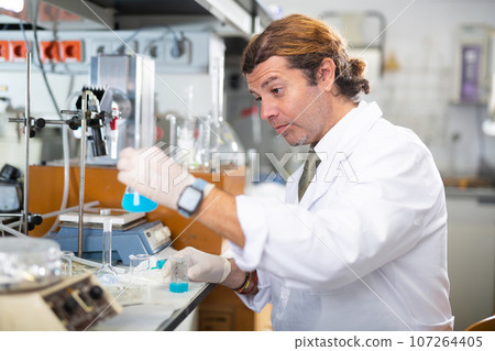 Confident man technician working in research laboratory Confident man technician working in research laboratory 107264405