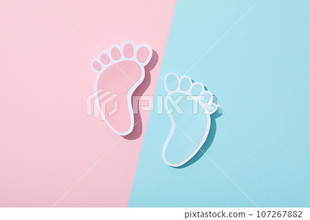 Paper feet on blue and pink background, top view 107267882