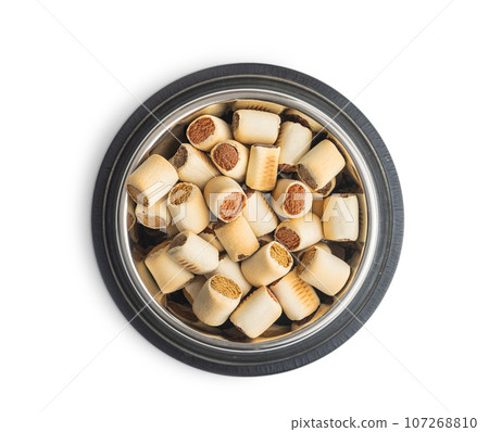 Dry animal food. Dog or cat kibble in bowl isolated on white background. Dry animal food. Dog or cat kibble in bowl isolated on white background. 107268810