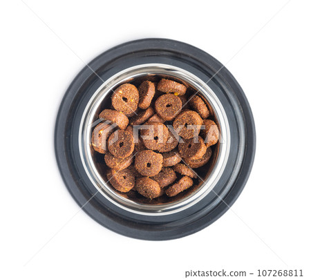 Dry animal food. Dog or cat kibble in bowl isolated on white background. Dry animal food. Dog or cat kibble in bowl isolated on white background. 107268811