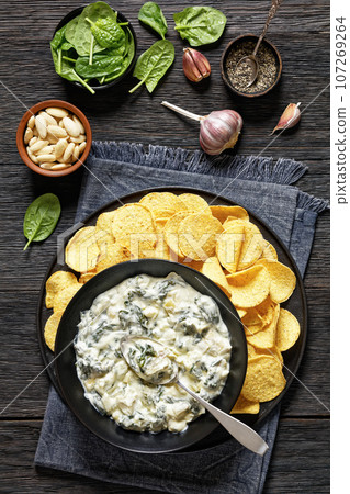 artichoke spinach almond dip with potato chips artichoke spinach almond dip with potato chips 107269264