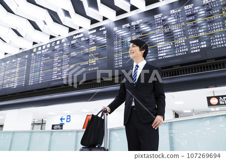 Young businessman going on a business trip from the airport Young businessman going on a business trip from the airport 107269694