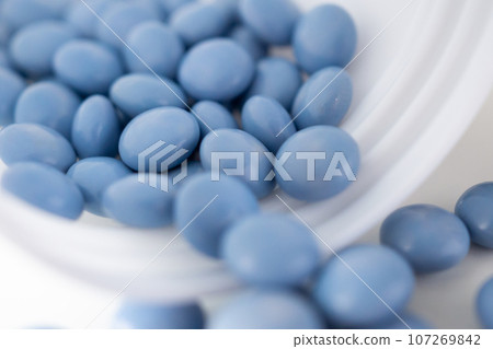 blue medicine pills with bottle on white background blue medicine pills with bottle on white background 107269842