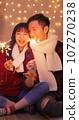 couple play sparkler together 107270238