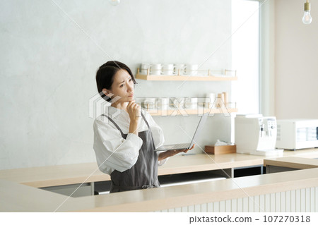 Cafe staff using computers Cafe staff using computers 107270318