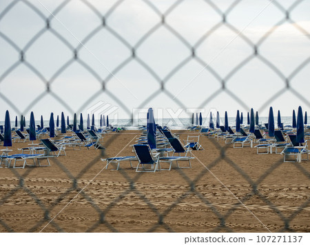 Closed beach parasol at empty seaside coast. Beach in Italy 107271137