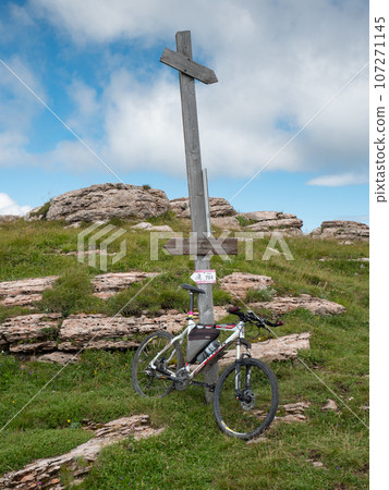 Mountain bikes at wooden tourist sign on mountain trail 107271145