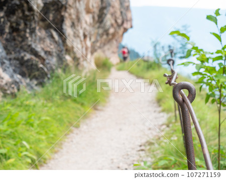 Rope and shackles anchored in hard dolomite limestone rock. Climbers path via ferrata. Rope and shackles anchored in hard dolomite limestone rock. Climbers path via ferrata. 107271159