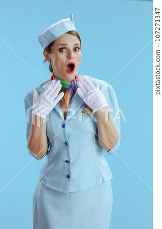 surprised modern female flight attendant on blue surprised modern female flight attendant on blue 107271347
