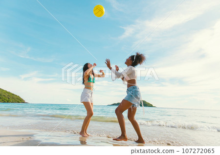 beautiful woman playing ball on the beach. 107272065