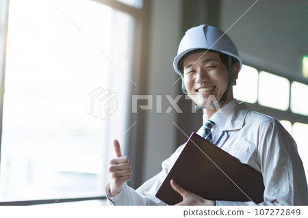 A man wearing work clothes 107272849