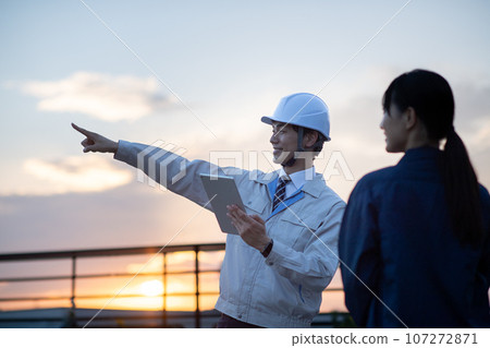 A man wearing work clothes A man wearing work clothes 107272871