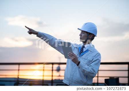 A man wearing work clothes A man wearing work clothes 107272873