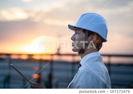 A man wearing work clothes A man wearing work clothes 107272878