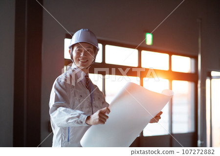 A man wearing work clothes 107272882