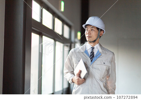 A man wearing work clothes A man wearing work clothes 107272894