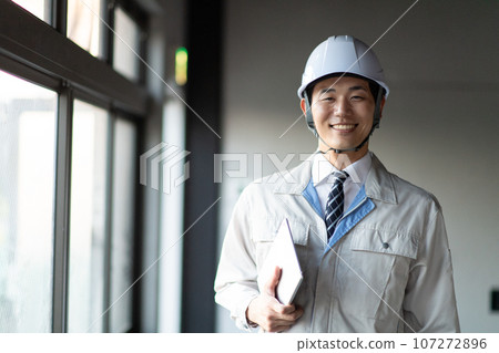A man wearing work clothes A man wearing work clothes 107272896