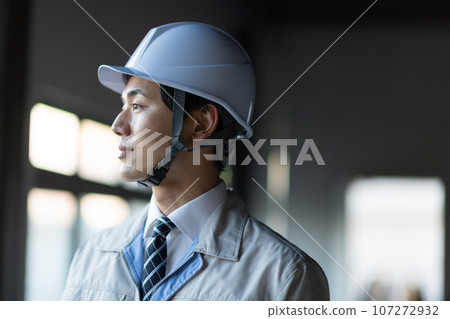 A man wearing work clothes A man wearing work clothes 107272932