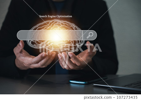Person using a laptop to brain manage search engine optimization SEO for a website, incorporating social media content and advertisement. intersection of technology, marketing, and business strategy. 107273435