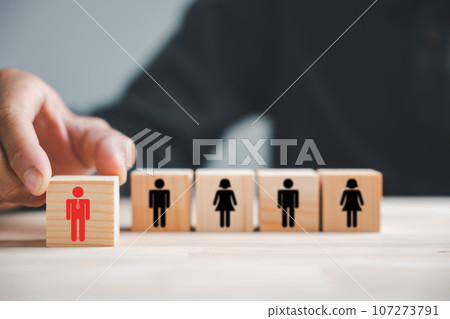 Hand carefully picks up red human icon on wooden block. Business hiring recruitment. Career opportunity. HR Management. Leadership in action. Choosing best fit for success. Human resource management 107273791