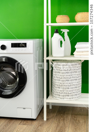 Modern white washing machine in a laundry room Modern white washing machine in a laundry room 107274346