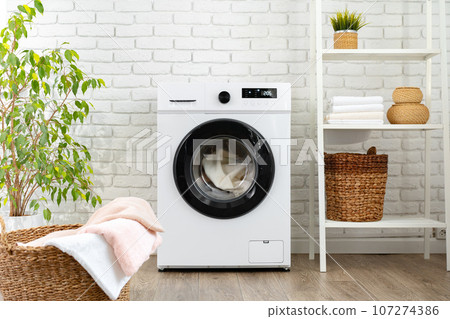 Modern white washing machine close up photo Modern white washing machine close up photo 107274386