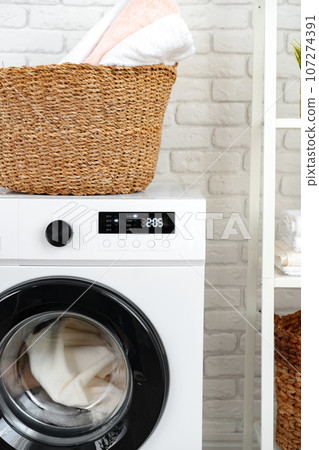 Laundry basket on washing machine in a laundry room Laundry basket on washing machine in a laundry room 107274391