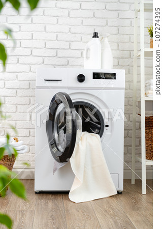 Detergent bottle on washing machine in a laundry room Detergent bottle on washing machine in a laundry room 107274395
