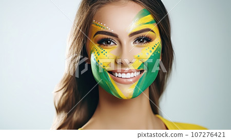 Young female with the flag of Brazil painted on her face on her way to a sporting event to show her support. 107276421