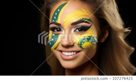 Young female with the flag of Brazil painted on her face on her way to a sporting event to show her support. 107276423