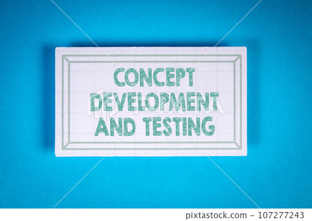 CONCEPT DEVELOPMENT AND TESTING. Cardboard sticker on a blue background CONCEPT DEVELOPMENT AND TESTING. Cardboard sticker on a blue background 107277243
