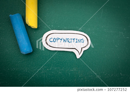 Copywriting Concept. Speech bubble with text on a green chalkboard background 107277252