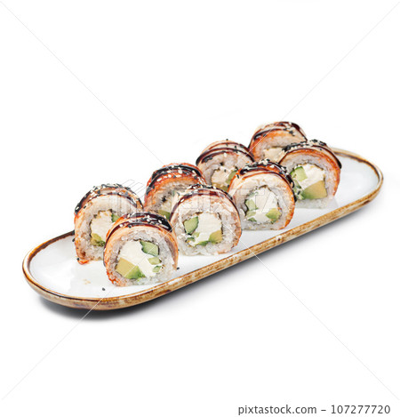 asian food - sushi roll with eel on plate on white background. asian food - sushi roll with eel on plate on white background. 107277720