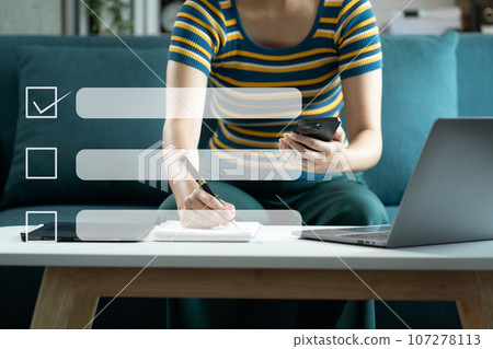 Business performance checklist concept, businessman using tablet and laptop doing online checklist survey, filling out digital form checklist. Business performance checklist concept, businessman using tablet and laptop doing online checklist survey, filling out digital form checklist. 107278113
