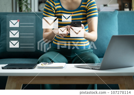 Email notification concept, Women use smartphone and laptop receive message alert in the mailbox. Email notification concept, Women use smartphone and laptop receive message alert in the mailbox. 107278114