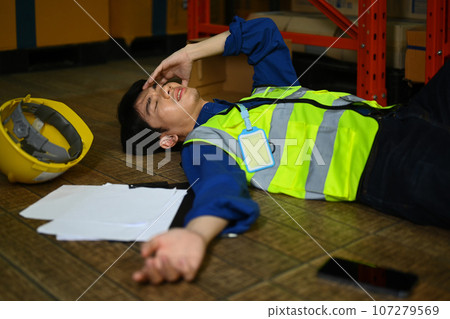 Warehouse workers with injured head lying on floor after an accident. Safety, and Insurance concept Warehouse workers with injured head lying on floor after an accident. Safety, and Insurance concept 107279569