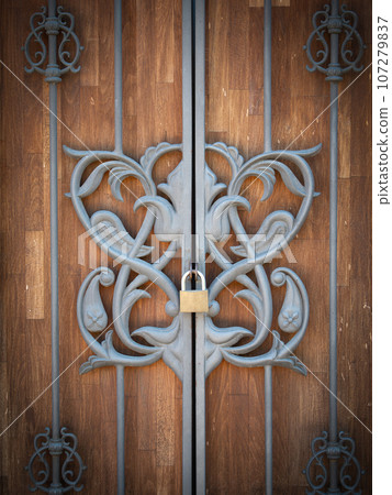 locked grates before wooden doors 107279837