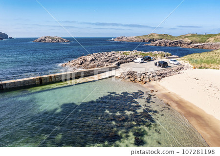 Aerial view of the north west pier on Cruit Island, Tobernoran, bay, County Donegal, Ireland 107281198
