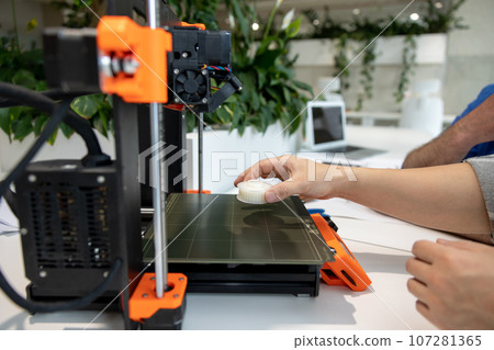 Engineers working with 3D printer process of printing. 107281365