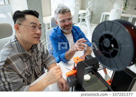 Creative team men colleagues working with three dimensional technology. 107281377