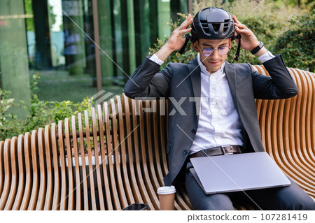 Young businessman putting on a protective hemlet 107281419