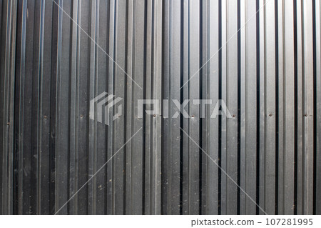 Black fence made of corrugated board, background 107281995