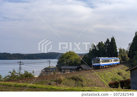 A railway train running with a view of Nanao Bay and Noto Island A railway train running with a view of Nanao Bay and Noto Island 107282540