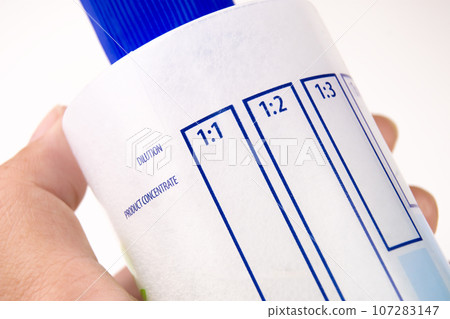 Close up a dilution ratio label of concentrated liquid chemicals on plastic bottles. Close up a dilution ratio label of concentrated liquid chemicals on plastic bottles. 107283147