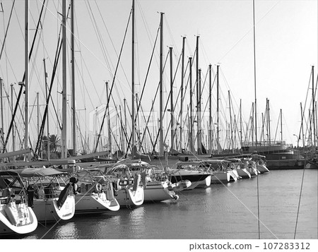 Beautiful yacht ship moored at port with other boats on blue salted sea Beautiful yacht ship moored at port with other boats on blue salted sea 107283312