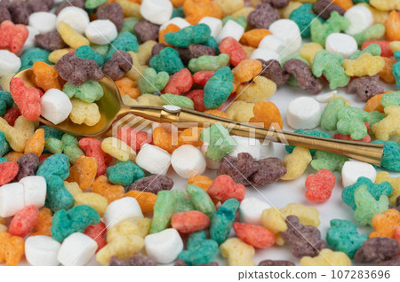 Gold spoon on colorful cornflakes 107283696