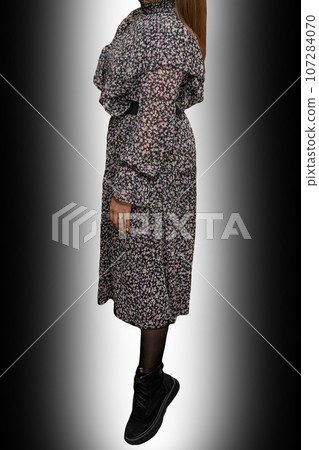 Slim girl in dress with abstract flower pattern women's fashion and clothing style posing on black and white background gradient 107284070