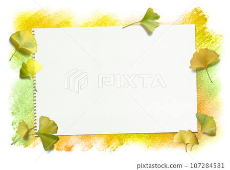 Autumn pastel background and sketchbook with bright fallen ginkgo leaves 107284581