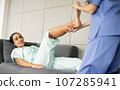 Female Caucasian physiotherapist rehabilitation with Hispanic patient. The doctor doing stretching on patient's pain body for therapy and recovery healthcare. 107285941