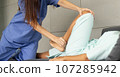 Female Caucasian physiotherapist rehabilitation with Hispanic patient. The doctor doing stretching on patient's pain body for therapy and recovery healthcare. 107285942